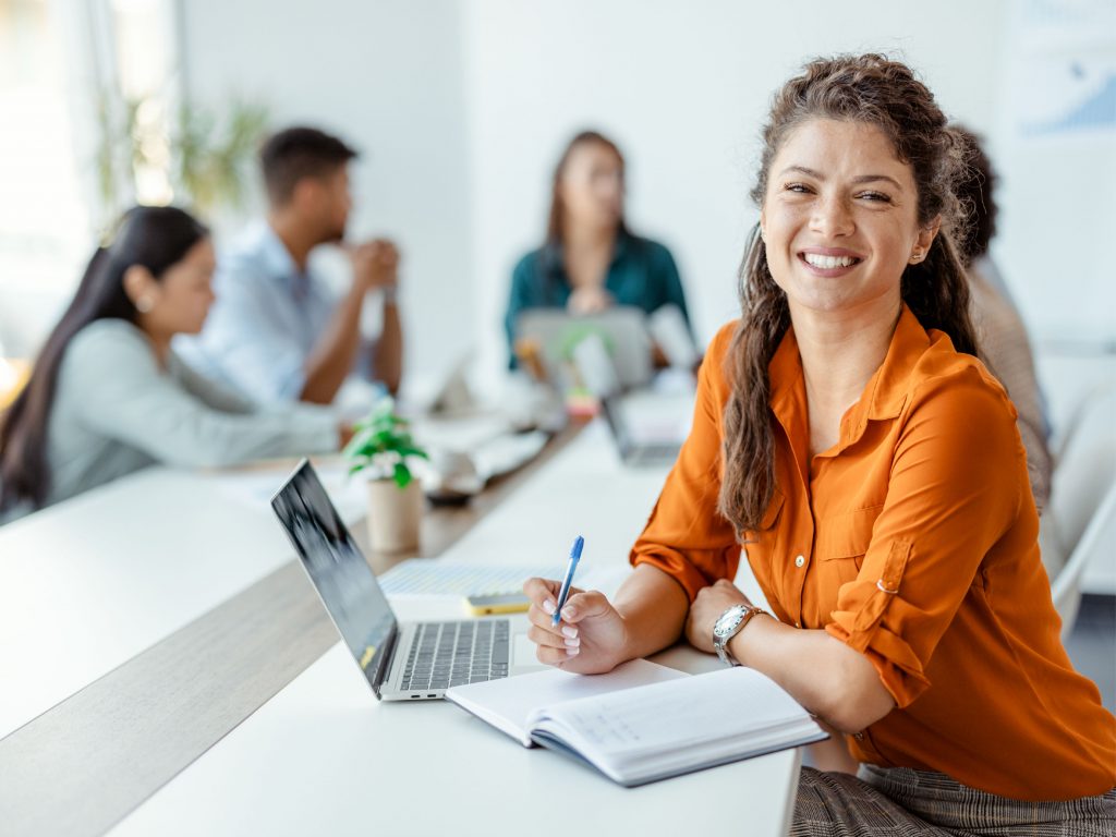 Businesswoman at A Meeting Sitting With Her Team.