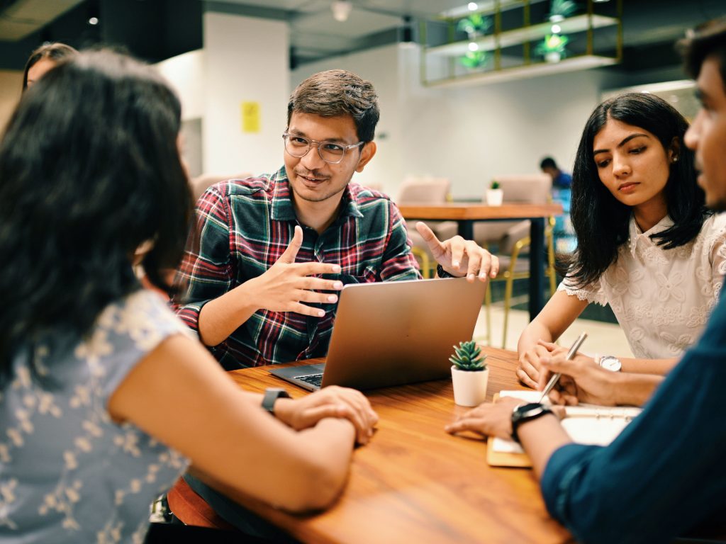 Group of young people discussing in the co-working office